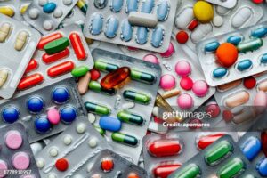 Health themes: Background of a large group of assorted capsules, pills and blisters. Drug abuse.